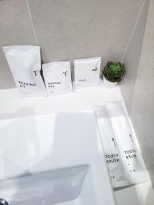 a white shelf with three pillows and a plant on it at 8 Kia Peng Residence Kuala Lumpur by Scape Stay in Kuala Lumpur