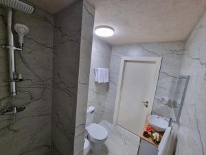 a bathroom with a white toilet and a shower at צימר נתיב המעיין in Ein Kinya +16 photos