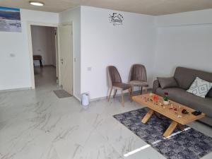 a living room with a couch and a table at צימר נתיב המעיין in Ein Kinya