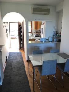 a kitchen with a table and chairs in a room at Il Ciliegio - House with Garden & Wonderful View in Pietra la Croce