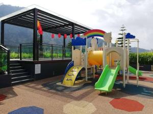 a childrens playground with a slide and a play structure at LOVEly 2 bedrooms Premier Suite Vista FREE WIFI in Genting Highlands
