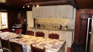 a dining room with a table and a kitchen at Ski La Cote in La Chapelle-dʼAbondance