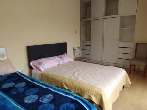 a bedroom with a bed and a chair and a closet at Apartamento frente al Palacio Gobierno in Lima