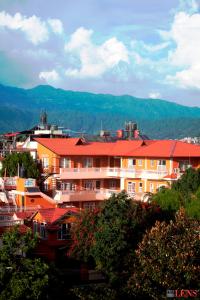 a group of buildings with red roofs on a hill at Melungtse apartment in Kathmandu