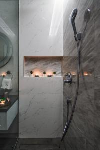 a shower with a shower head in a bathroom at DiVine Luxury Apartment Blue in Zadar