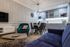 a living room with a blue couch and a table at DiVine Luxury Apartment Blue in Zadar