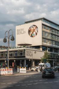 a large building with a clock on the side of it at Henri Hotel Berlin Kurfürstendamm in Berlin
