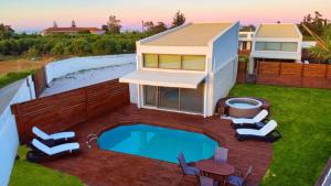 a house with a swimming pool in the yard at Cocoon Luxury Villas in Maleme +51 photos