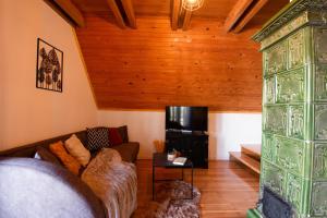 a living room with a couch and a television at Cottage Gordana in Begovo Razdolje