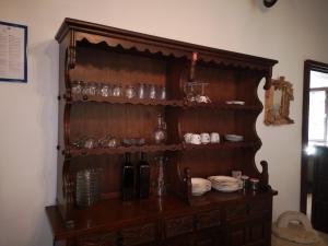 a wooden cabinet with plates and glasses on it at Holiday Home Božo in Korčula