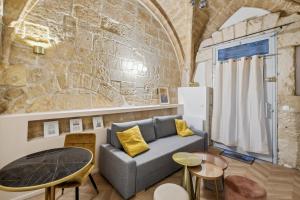 ein Wohnzimmer mit einem Sofa und einem Tisch in der Unterkunft Hyper centre Écusson - Magnifique T1 au calme in Montpellier