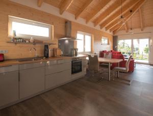 a kitchen with a table and a dining room at Blaues Ferienhaus Wernigerode in Wernigerode