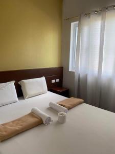 Ένα ή περισσότερα κρεβάτια σε δωμάτιο στο Travelers Inn Matina