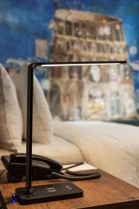 a computer monitor sitting on top of a table at Theory Hotel in Tbilisi City
