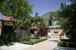 a house with a hill in the background at Hotel Los Olivos Spa in Oaxaca City