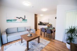 a living room with a couch and a table at Galeria Apartments in Demanovska Dolina