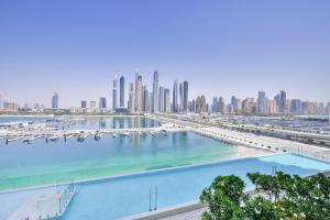 uitzicht op een jachthaven met een stad op de achtergrond bij Ultra Luxury Emaar Beachfront - Private Beach and Pool in Dubai
