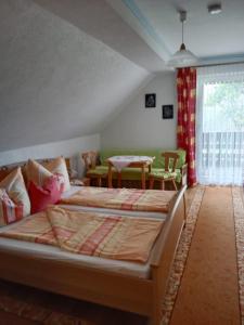 a bedroom with two beds and a table at Ferienwohnung Haus Gatternig in Seeboden