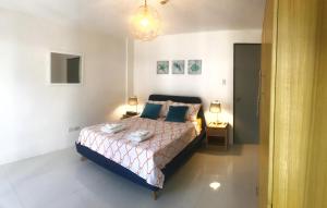 um quarto com uma cama com dois candeeiros em UNWND Residences Dumaguete em Dumaguete