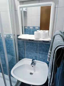 a bathroom with a white sink and a mirror at Motel Gas-Petrol Samac in Bosanski Šamac