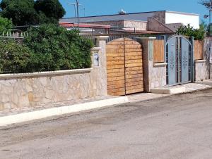 un edificio con una puerta y una pared de piedra en Finestre Sul Mare Salento - Case Vacanze, en Punta Prosciutto