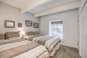 two beds in a room with a window at Columbine 206 in Breckenridge +28 photos