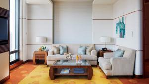 a living room with a couch and a coffee table at The Peninsula Tokyo in Tokyo