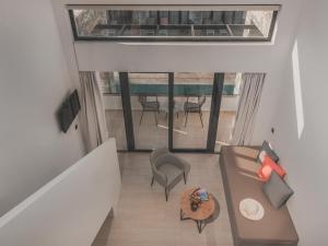 an overhead view of a living room with a couch and chairs at CAVO SUITES in Kalamaki