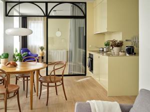 a kitchen and dining room with a table and chairs at Apēron Apartment Hotel in Copenhagen