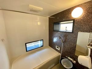 a bathroom with a tub and a toilet and a sink at Polar Haus Canadian NishiKaruisawa1 - Vacation STAY 07669v in Oiwake