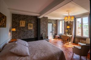 a bedroom with a large bed and a living room at Au Chantecler 
