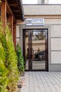 a sign that reads coffee revolving door at 281 Hotel in Bishkek