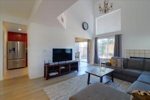 ein Wohnzimmer mit einem Sofa und einem TV in der Unterkunft @ Marbella Lane - 4BR City Escape in Hayward in Hayward