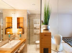 a bathroom with a sink and a mirror at Hotel Heinzler am See in Immenstaad am Bodensee