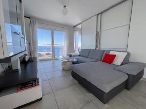 a living room with a couch and a flat screen tv at Ferienhaus Ivanka in Trogir