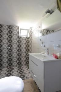 ein Badezimmer mit einem weißen Waschbecken und einem WC in der Unterkunft Santa Barbara lux studio in Marathonas in Lófos