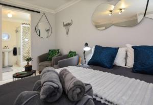 a bedroom with a large bed and a living room at Flatlet 2.1km from Iconic Blaauwberg Beach in Cape Town