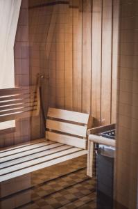 a sauna with a wooden bench and a sink at Henri Hotel Hamburg Downtown in Hamburg