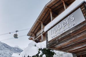 a sign for a ski lodge with a ski lift at Huber's Boutique Hotel in Mayrhofen