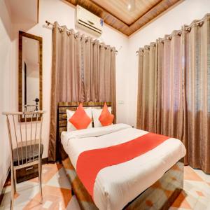 a bedroom with a bed and a chair at Hotel Snehaprabha - Near to Nagaon Beach Alibaug in Alibaug +66 photos