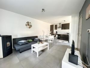 a living room with a couch and a table at Albert 18 Brussels-charleroi-airport in Charleroi