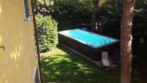 a swimming pool in a yard next to a house at Villa Mirano Bed & Breakfast in Piossasco