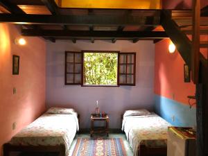 Postel nebo postele na pokoji v ubytování Eco-Flats Cachoeira Azul