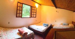 Postel nebo postele na pokoji v ubytování Eco-Flats Cachoeira Azul