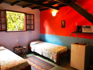 Postel nebo postele na pokoji v ubytování Eco-Flats Cachoeira Azul