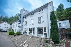 a white building with a sign on the side of it at Taste Smart Hotel Backnang in Backnang