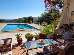 a patio with a pool and a table and chairs at LOS MORALICOS AGUA AMARGA in Agua Amarga
