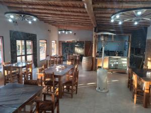 a restaurant with tables and chairs and a kitchen at Rincón Azul in San Rafael