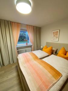 1 dormitorio con 2 camas y ventana en Christianes Apartment - Ebstorf, en Ebstorf