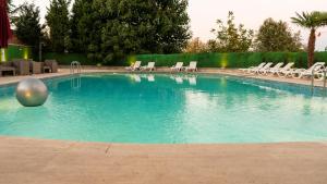 a swimming pool with chairs and a ball in the water at MOX Hotel Wellness & Spa in Sapanca